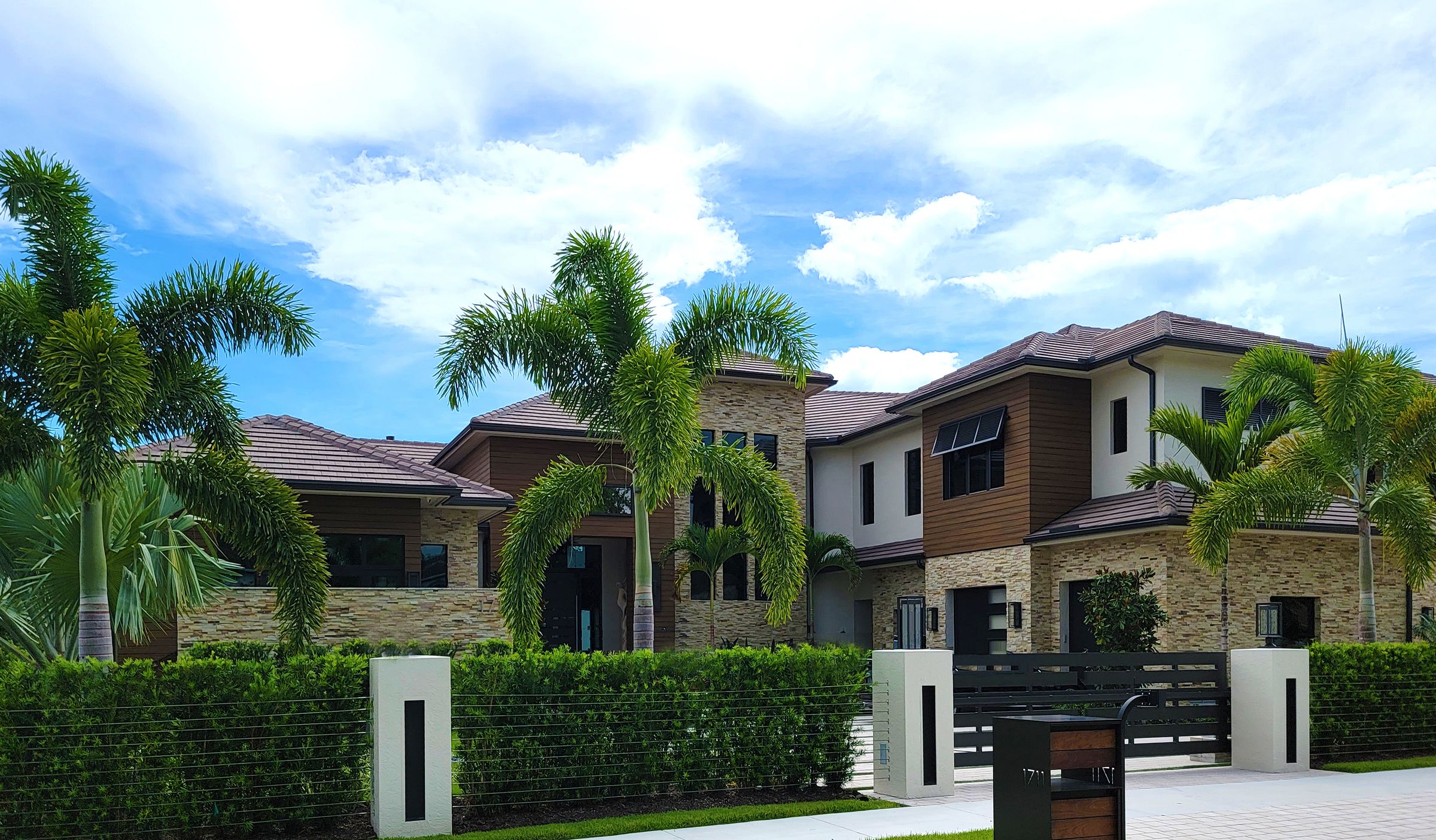 A sunlit home with landscaped grounds